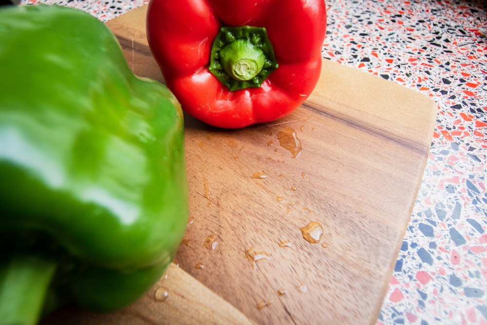 green bell pepper on brown wooden table